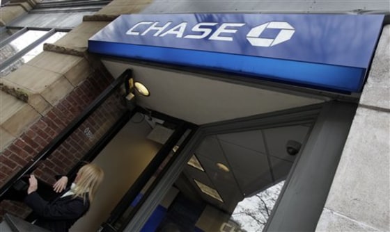 A woman exits a Chase branch in New York, Tuesday, April 13, 2010. JPMorgan Chase & Co. said Wednesday, April 14, its profit rose 57 percent in the first three months of the year as strong trading revenue helped the bank offset continuing losses on consumer loans. (AP Photo/Richard Drew)